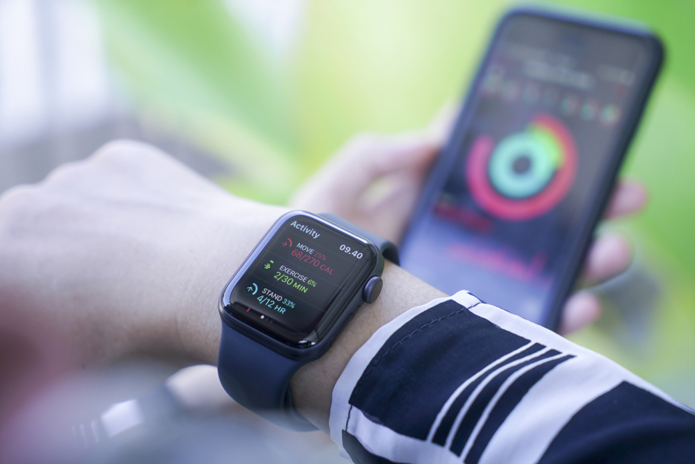 Bali Indonesia 2 April 2020 : Woman using smart watch and smart phone, Apple watch