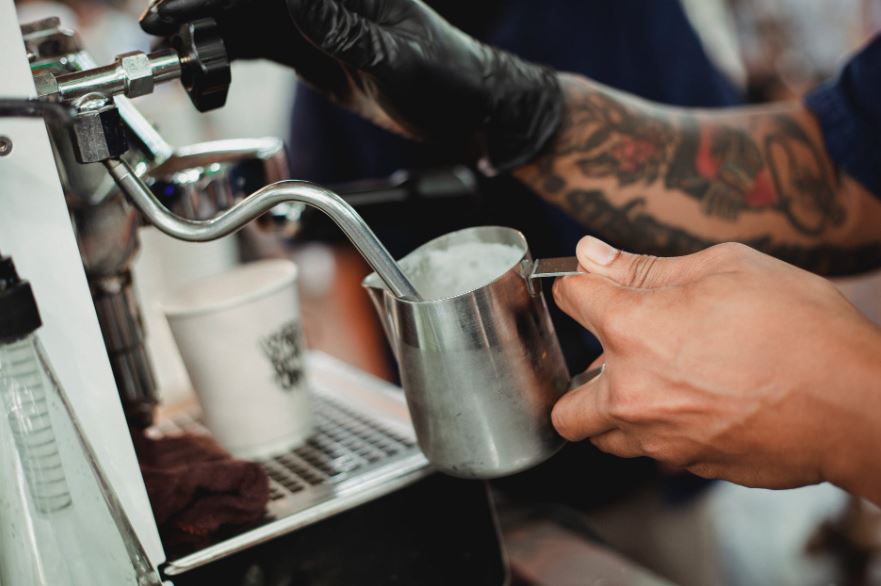 Barista frothing milk