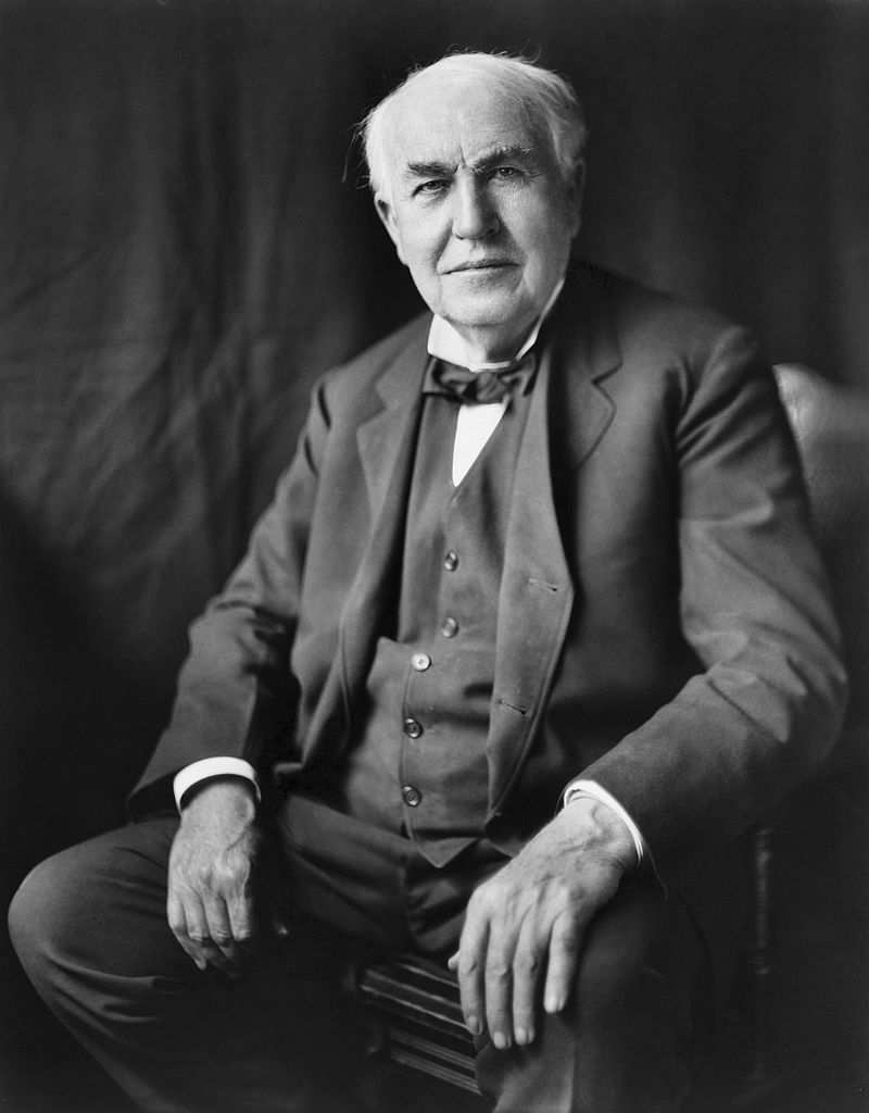 Thomas Edison cartoon holding a light bulb