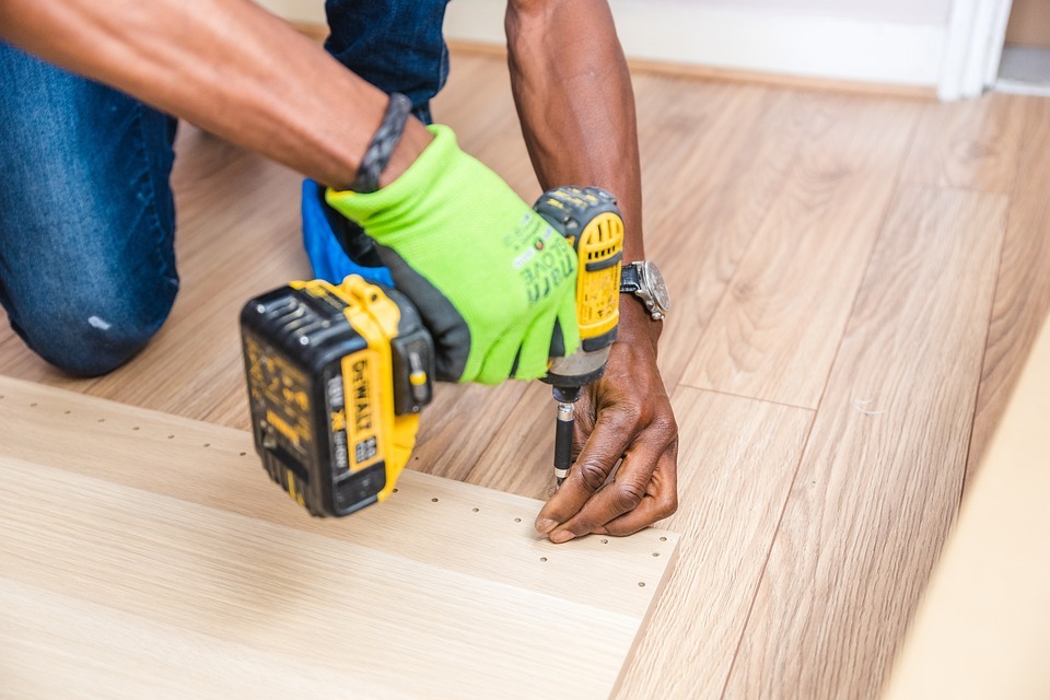 Handyman using a yellow cordless power drill
